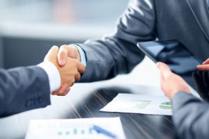 Two men in suits shaking hands