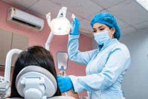 Dentist adjust light for patient